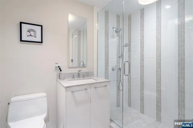 a bathroom with a toilet sink and shower