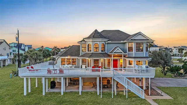 a aerial view of a house with a yard table and chairs