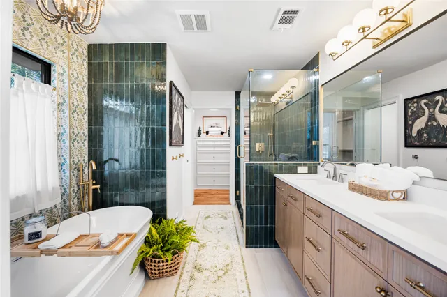 a bathroom with a bathtub sink and mirror