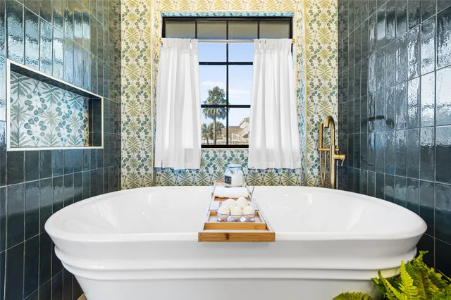 a bedroom with a bed lamp and a window