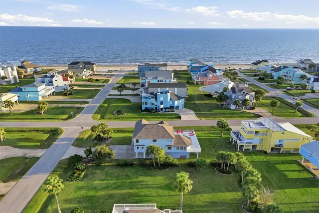 an aerial view of multiple houses with yard