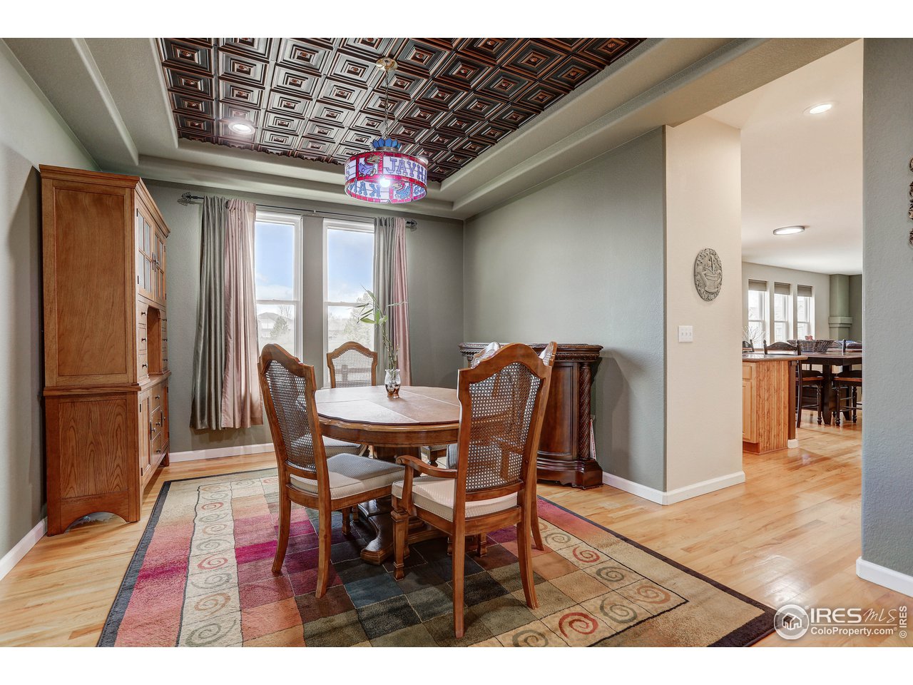 709 Glenarbor Circle Longmont, CO 80504 - Photo 12 of 40 a view of a dining room with furniture and wooden floor