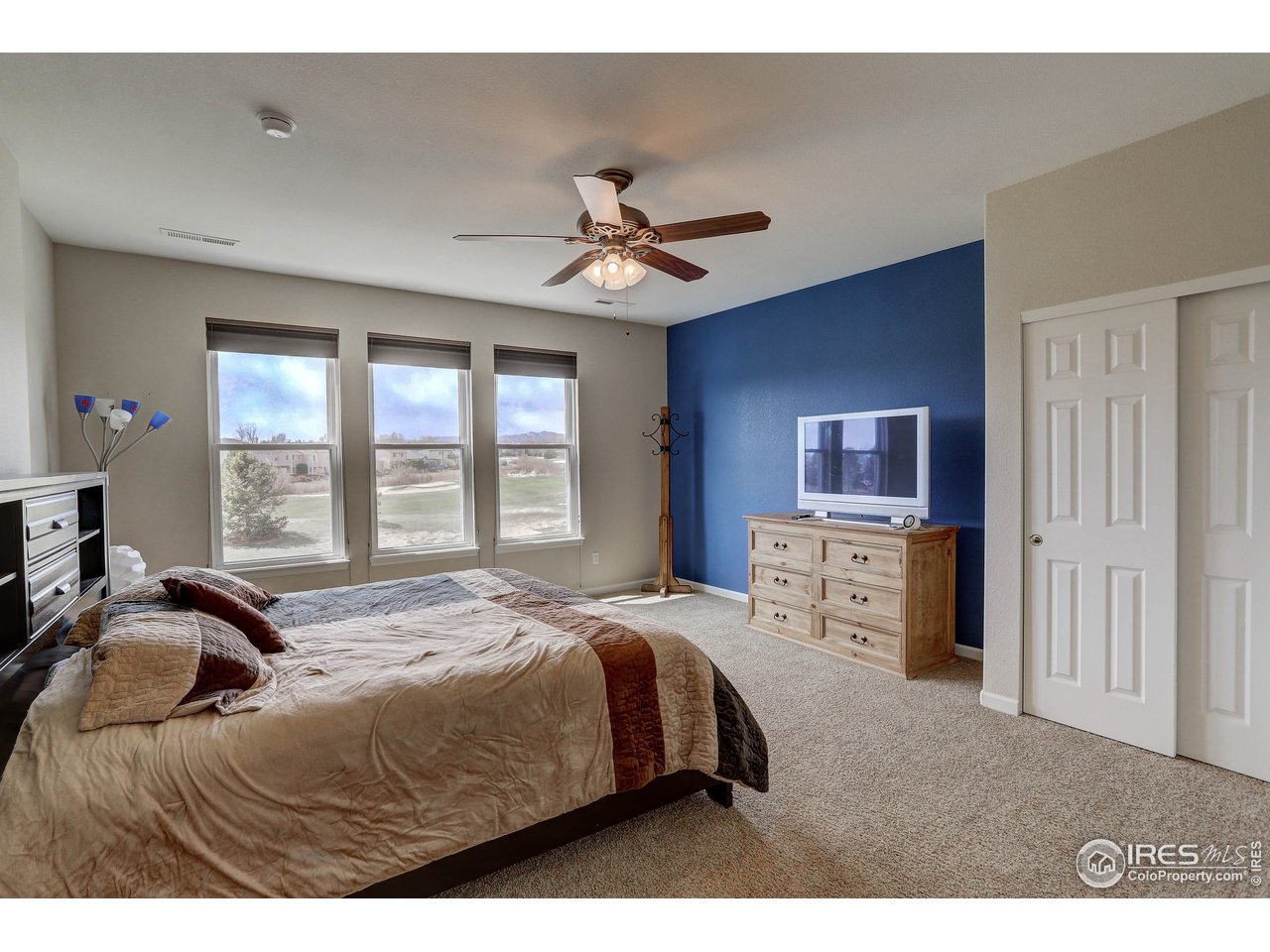 709 Glenarbor Circle Longmont, CO 80504 - Photo 28 of 40 a bedroom with a bed and a flat screen tv