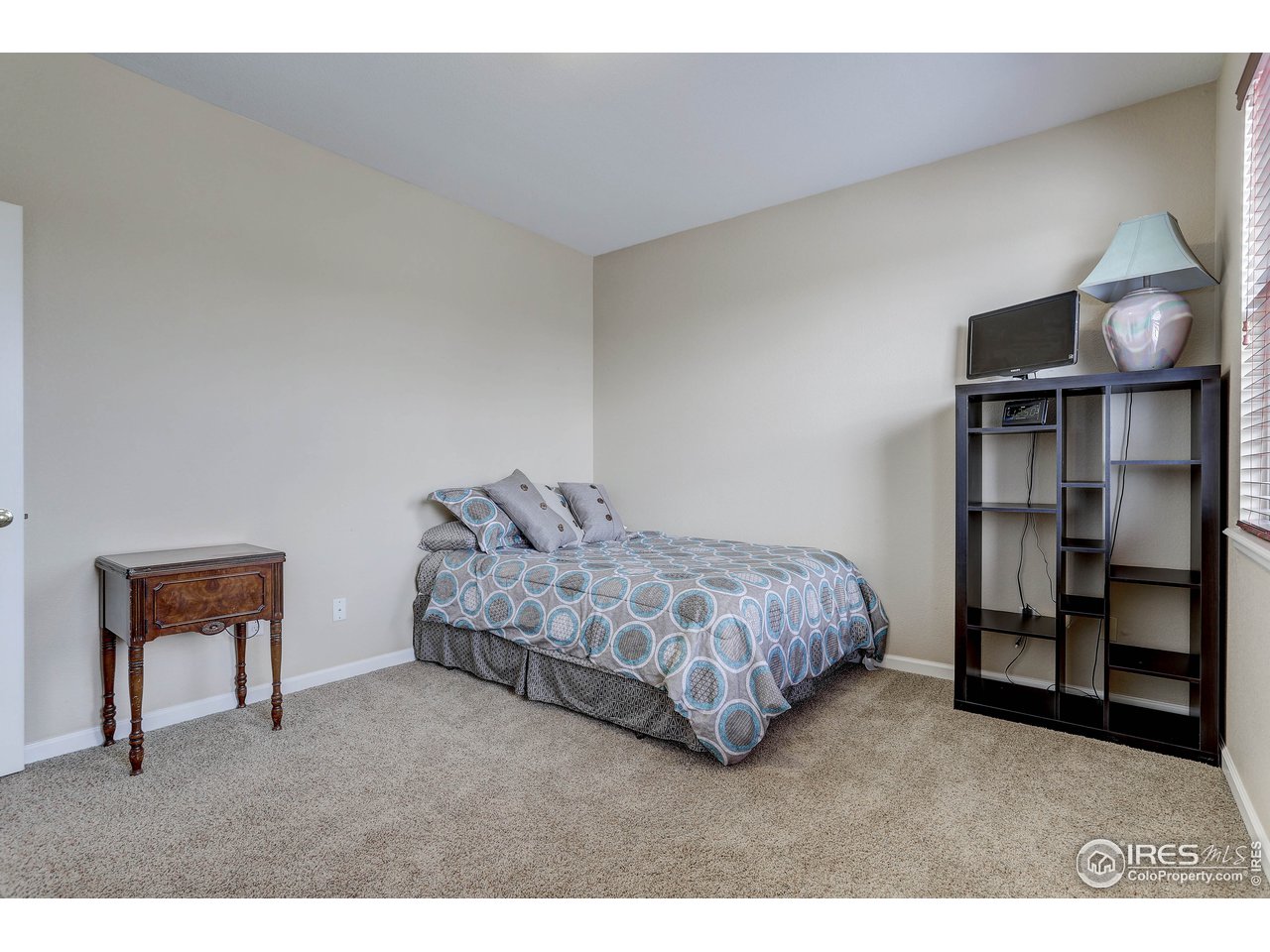 709 Glenarbor Circle Longmont, CO 80504 - Photo 29 of 40 a spacious bedroom with a bed and a cabinets