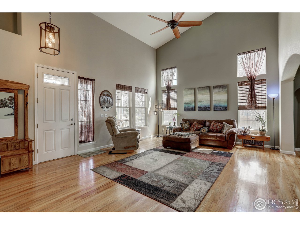 709 Glenarbor Circle Longmont, CO 80504 - Photo 9 of 40 a living room with furniture and a wooden floor