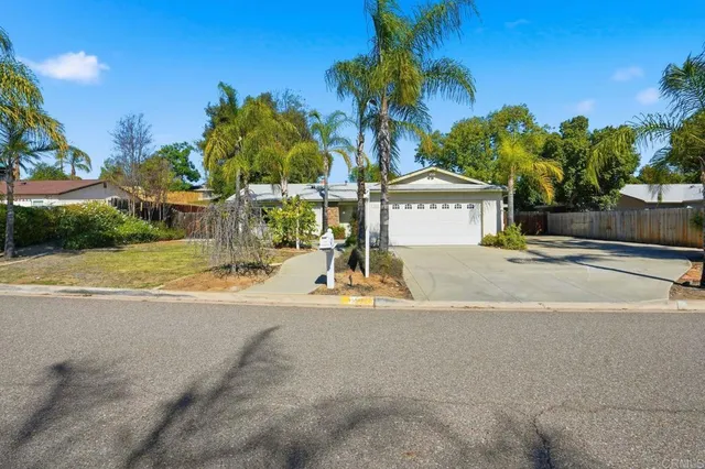 a sign board with palm trees