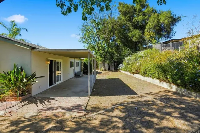 a view of a street with potted plants