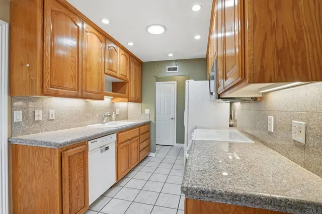 a kitchen with stainless steel appliances granite countertop a sink and cabinets