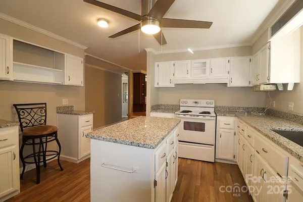 a kitchen with a stove a sink and a refrigerator