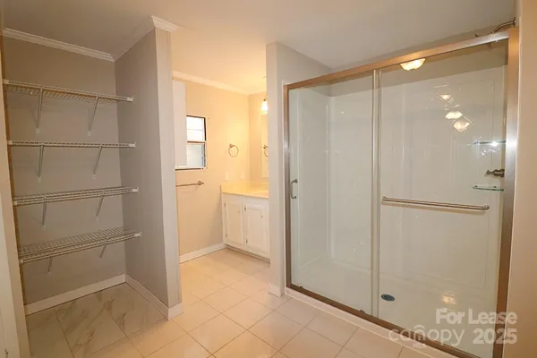 a bathroom with a shower and a glass door