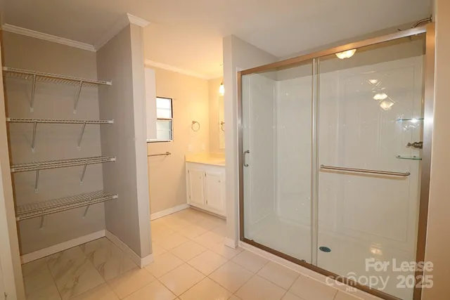 a bathroom with a shower and a glass door