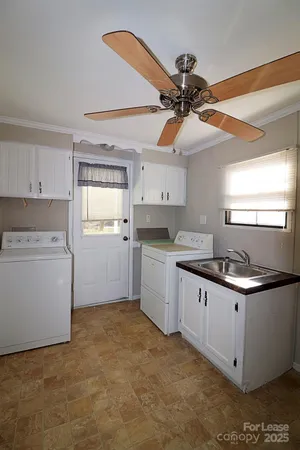a kitchen with a sink a stove and cabinets