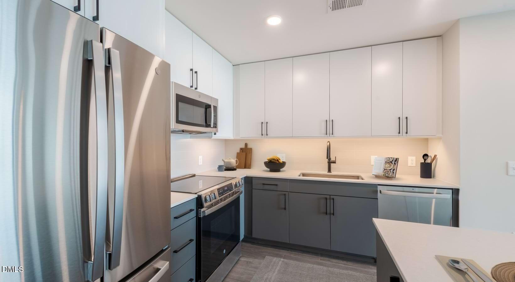 1000 Hammell Drive, Unit S3 Raleigh, NC 27603 - Photo 15 of 35 a kitchen with a sink refrigerator and microwave