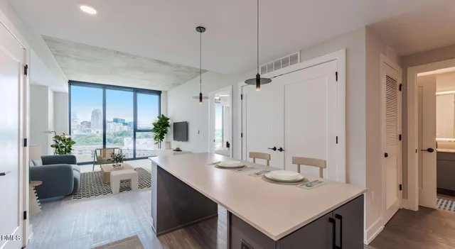 a kitchen with kitchen island a refrigerator stove and sink