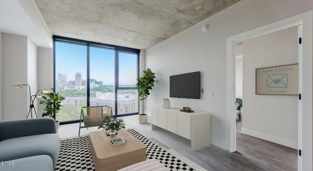 a living room with furniture a rug and a table