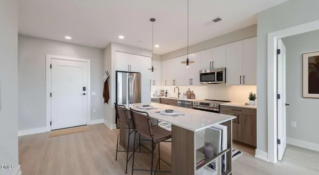 a living room with furniture a flat screen tv and a window