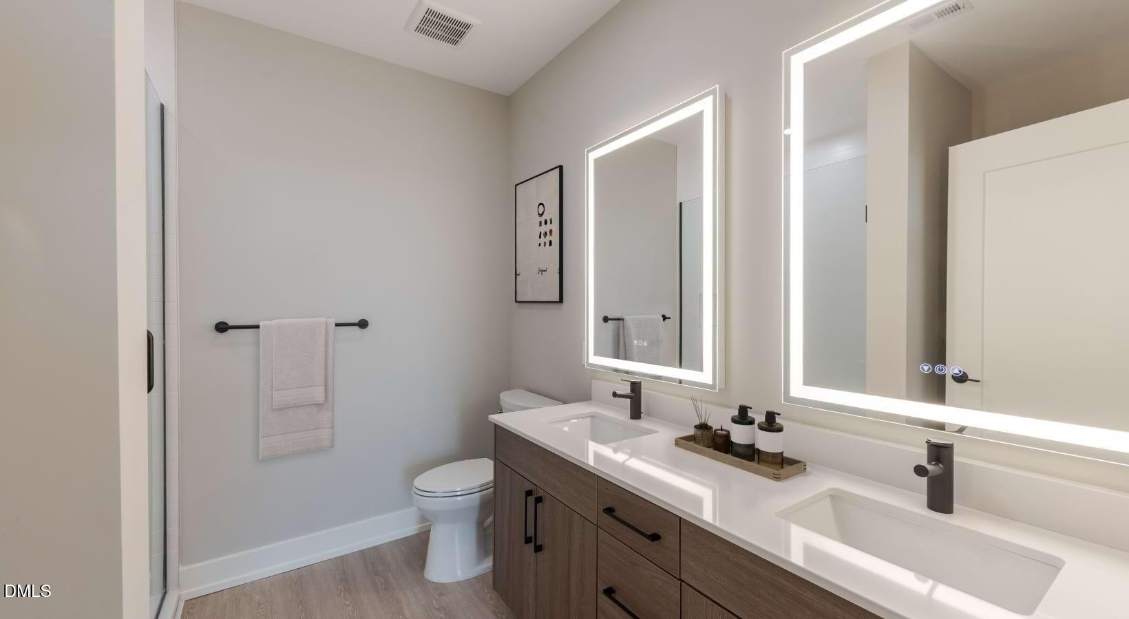 1000 Hammell Drive, Unit S3 Raleigh, NC 27603 - Photo 33 of 35 a bathroom with a sink toilet double vanity and shower