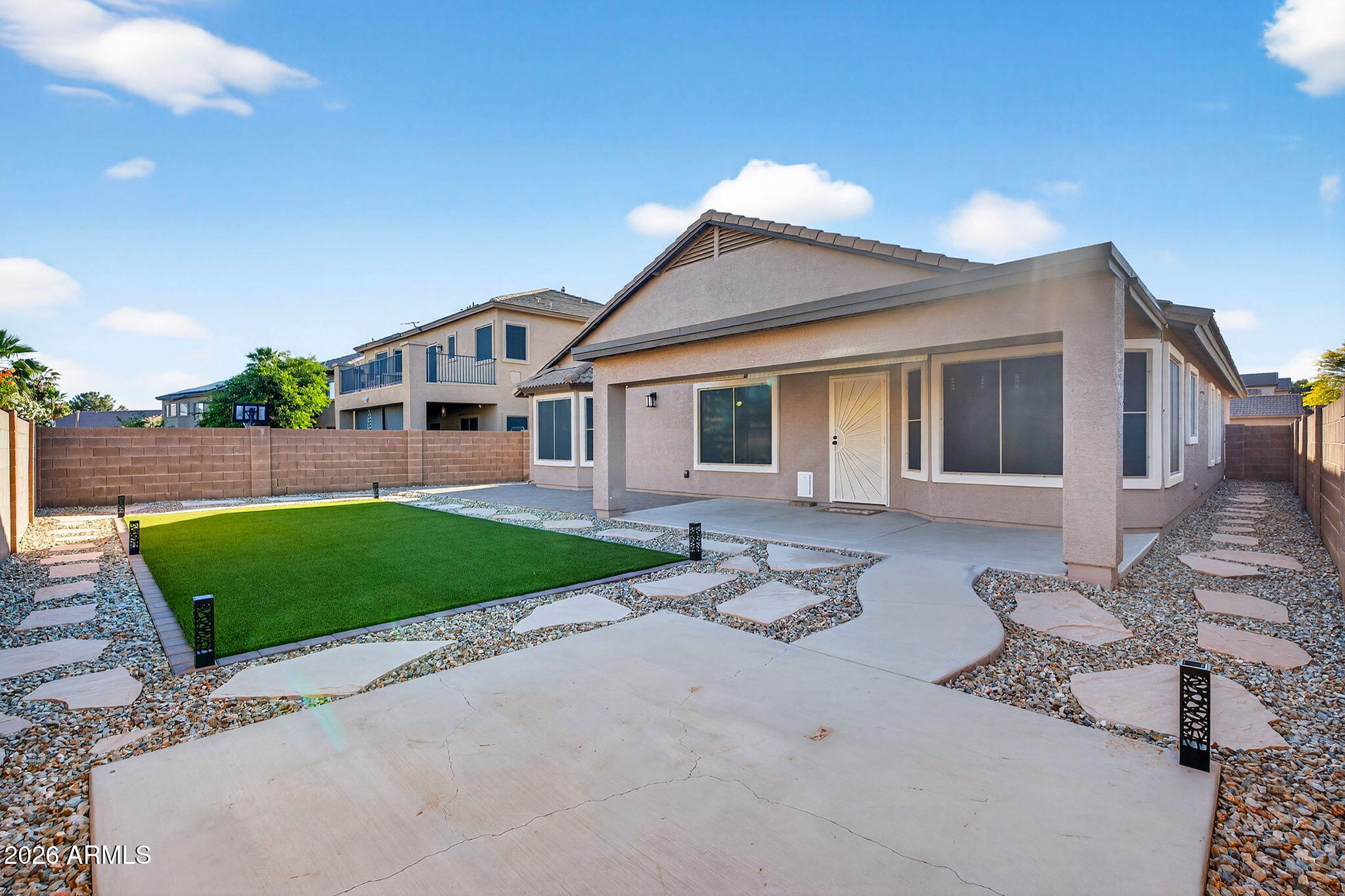 1815 South 174th Avenue Goodyear, AZ 85338 - Photo 20 of 57 a front view of a house with a garden and patio