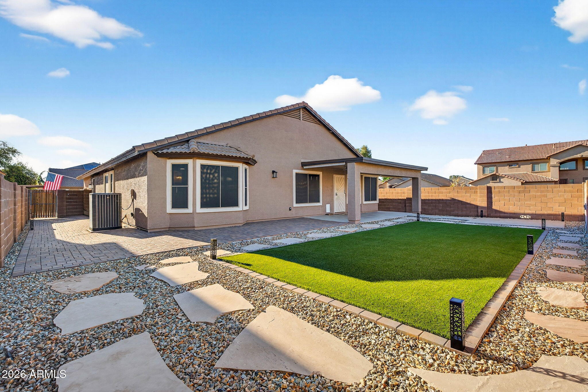 1815 South 174th Avenue Goodyear, AZ 85338 - Photo 22 of 57 a view of a house with a swimming pool and a yard
