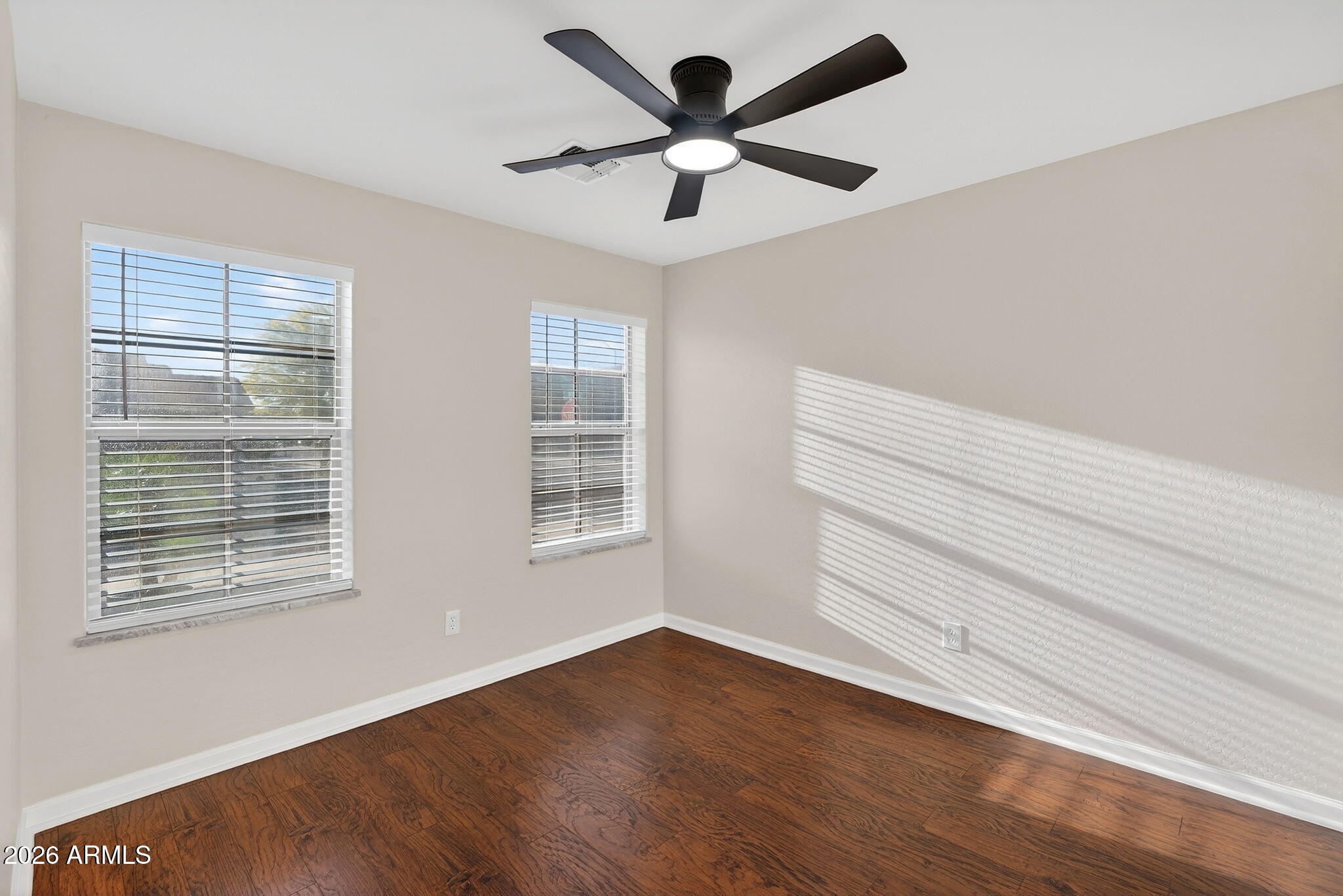 1815 South 174th Avenue Goodyear, AZ 85338 - Photo 39 of 57 a view of an empty room with a window and wooden floor