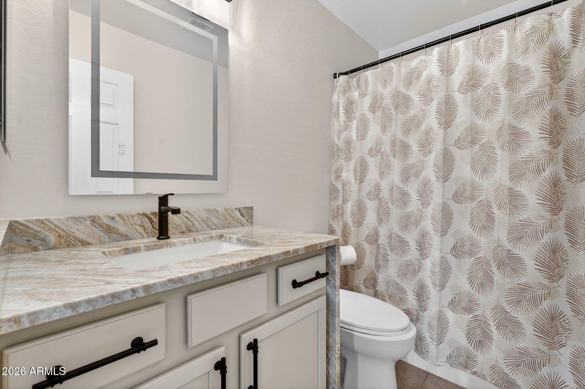 1815 South 174th Avenue Goodyear, AZ 85338 - Photo 42 of 57 a bathroom with a granite countertop sink a toilet and a mirror
