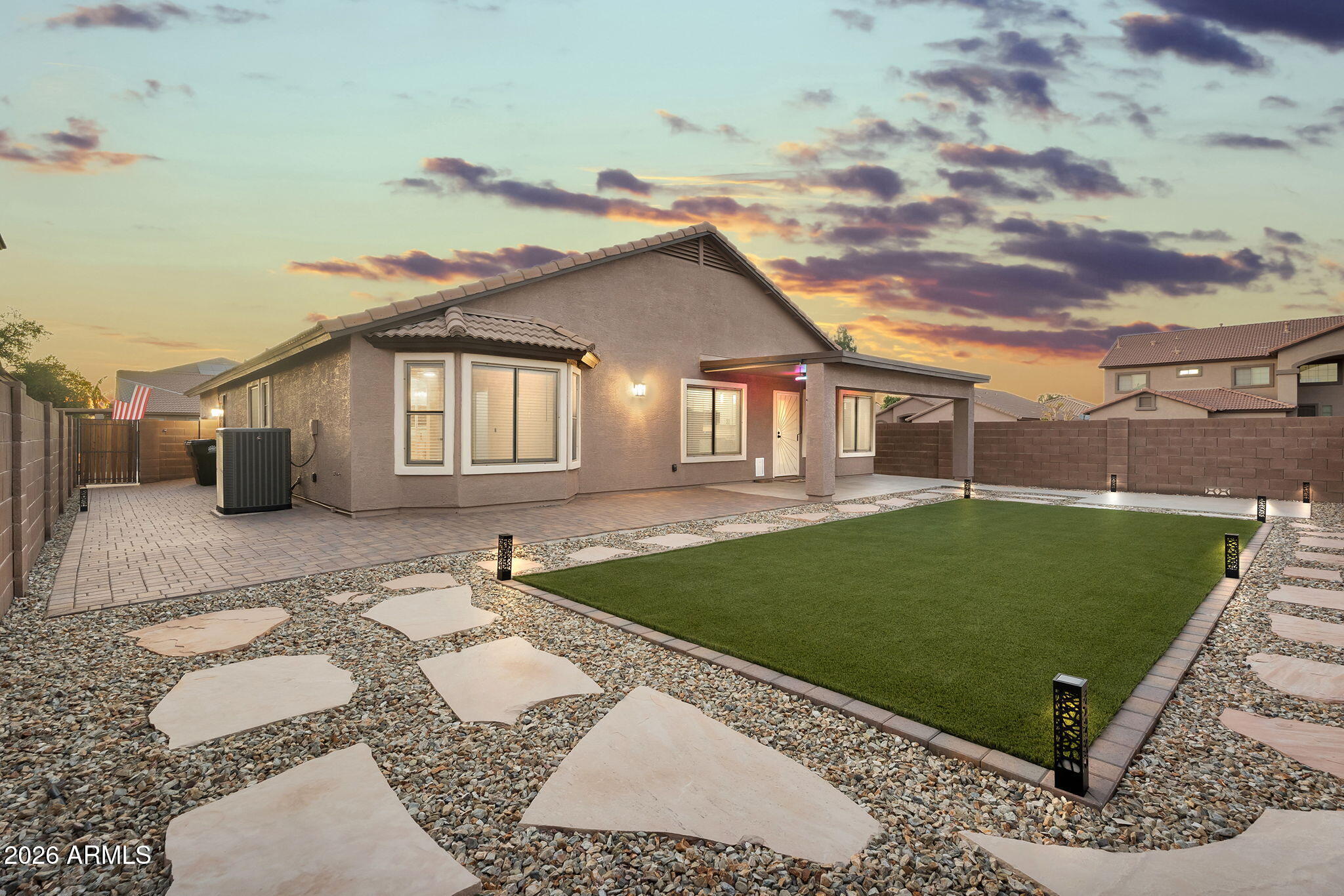 1815 South 174th Avenue Goodyear, AZ 85338 - Photo 4 of 57 a front view of a house with a garden