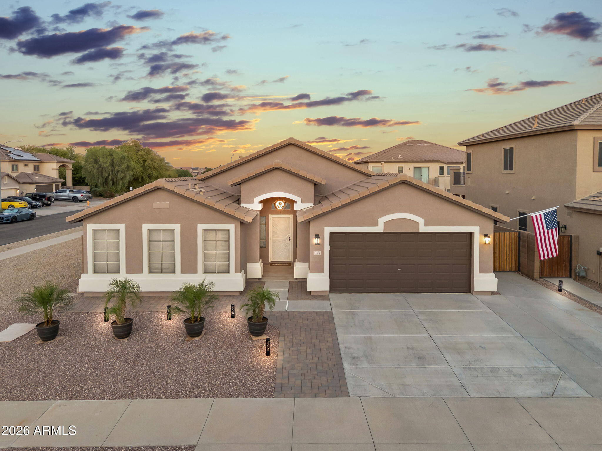 1815 South 174th Avenue Goodyear, AZ 85338 - Photo 7 of 57 a front view of a house with a yard and garage