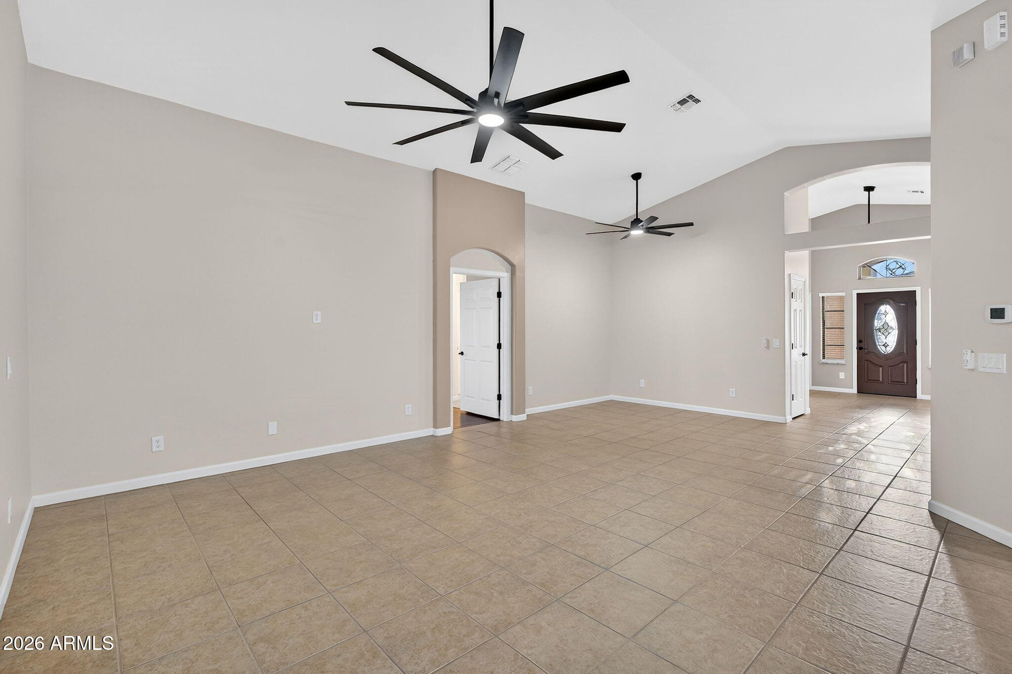 1815 South 174th Avenue Goodyear, AZ 85338 - Photo 8 of 57 a view of a livingroom with a ceiling fan and wooden floor