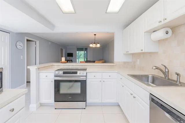 a kitchen with white cabinets and a sink