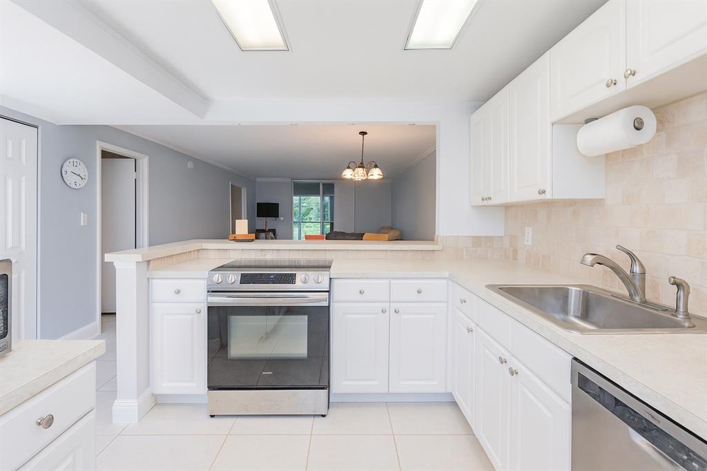 6161 Northwest 2nd Avenue, Unit 121 Boca Raton, FL 33487 - Photo 1 of 20 a kitchen with white cabinets and a sink