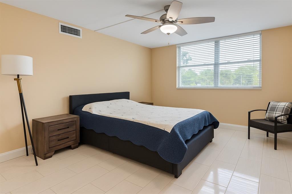 6161 Northwest 2nd Avenue, Unit 121 Boca Raton, FL 33487 - Photo 12 of 20 a spacious bedroom with a bed dresser and a window