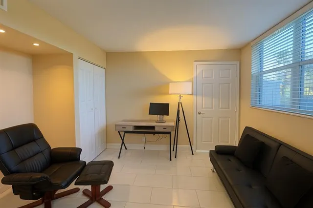 a work room with furniture and a window