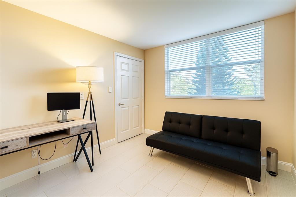 6161 Northwest 2nd Avenue, Unit 121 Boca Raton, FL 33487 - Photo 9 of 20 a living room with furniture and a flat screen tv