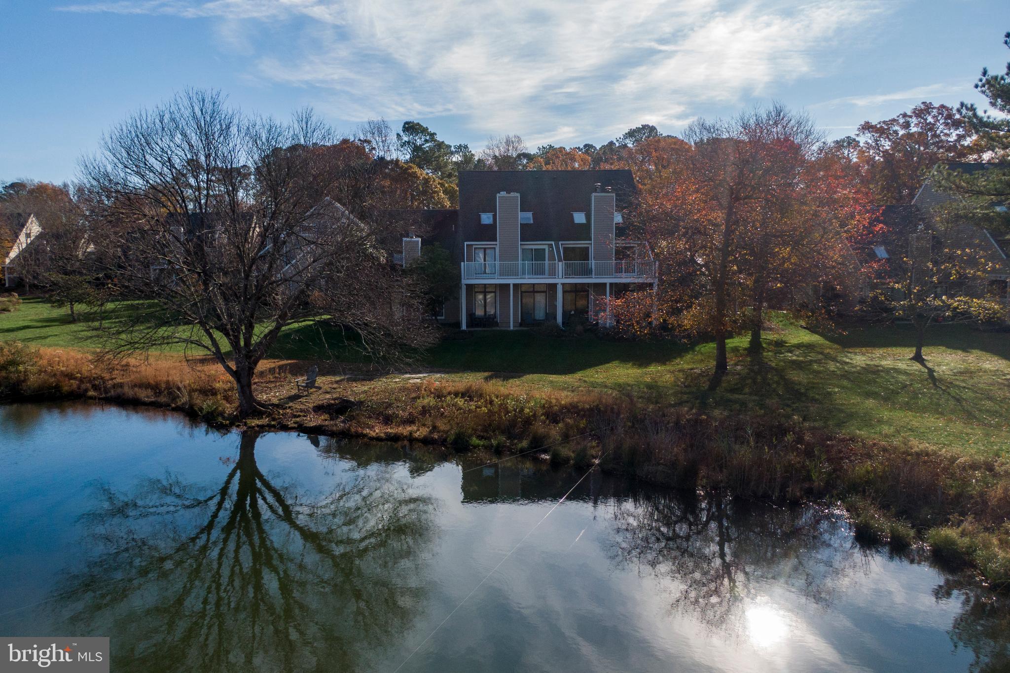 20852 Spring Lake Drive, Unit 405 Rehoboth Beach, DE 19971 - Photo 37 of 45 a view of a lake with outside house