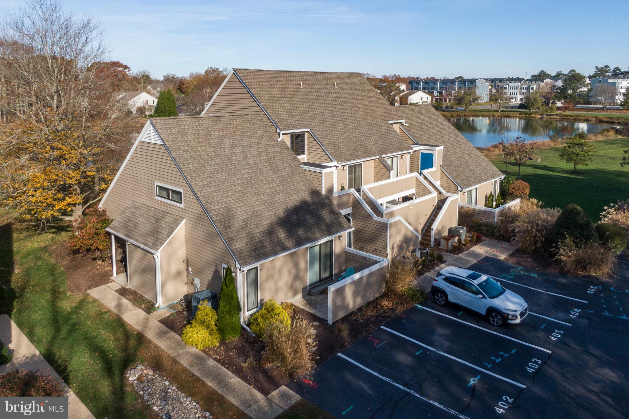 20852 Spring Lake Drive, Unit 405 Rehoboth Beach, DE 19971 - Photo 44 of 45 an aerial view of multiple houses with yard