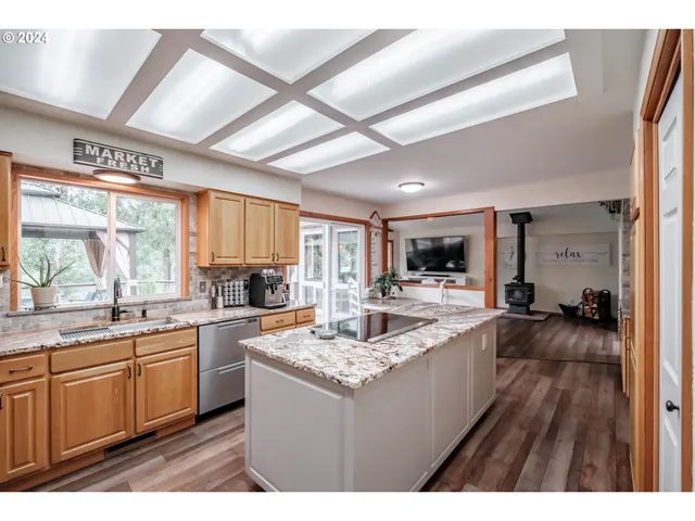 a kitchen with sink stove and cabinets