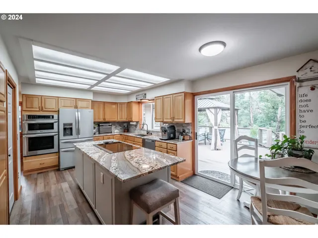 a kitchen with a stove a refrigerator and wooden cabinets