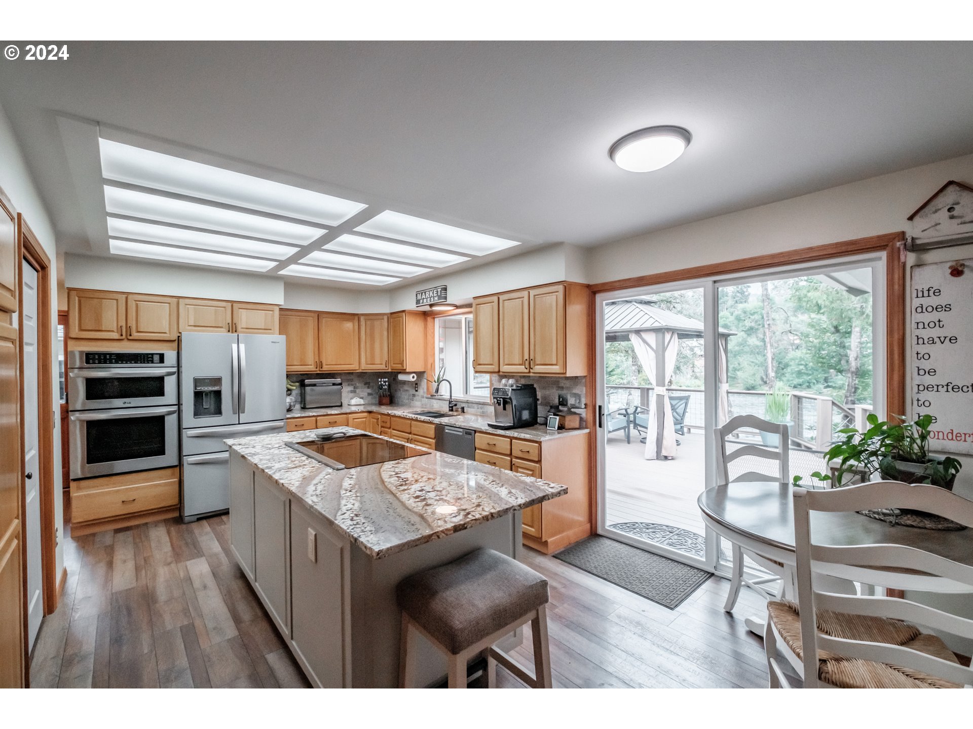 40166 Gates School Road Gates, OR 97346 - Photo 13 of 47 a kitchen with a stove a refrigerator and wooden cabinets