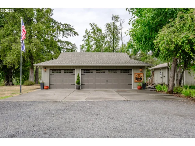 a front view of a house with a yard and a garage