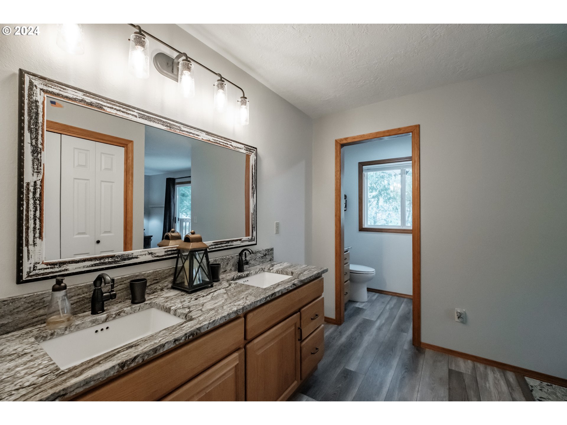 40166 Gates School Road Gates, OR 97346 - Photo 32 of 47 a bathroom with a granite countertop sink mirror and vanity