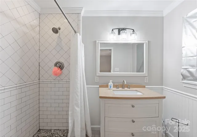 a bathroom with a sink vanity and a mirror