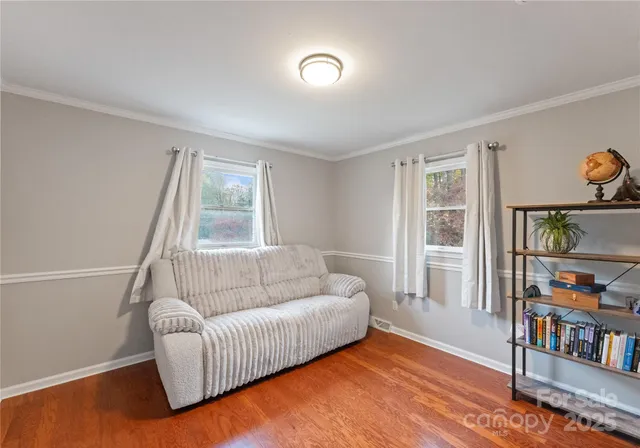 a living room with furniture and a book shelf