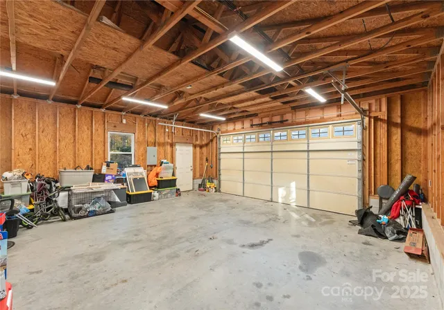 a view of a garage with storage and utility room