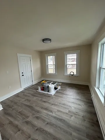 a room with a window and a wooden floor