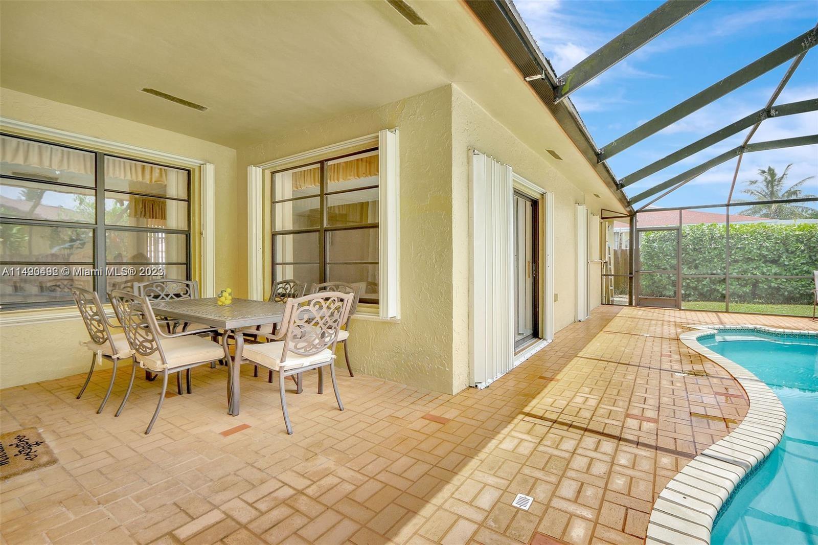 Palmetto Estates Miami, FL 33157 - Photo 12 of 26 a dining room with furniture and large windows