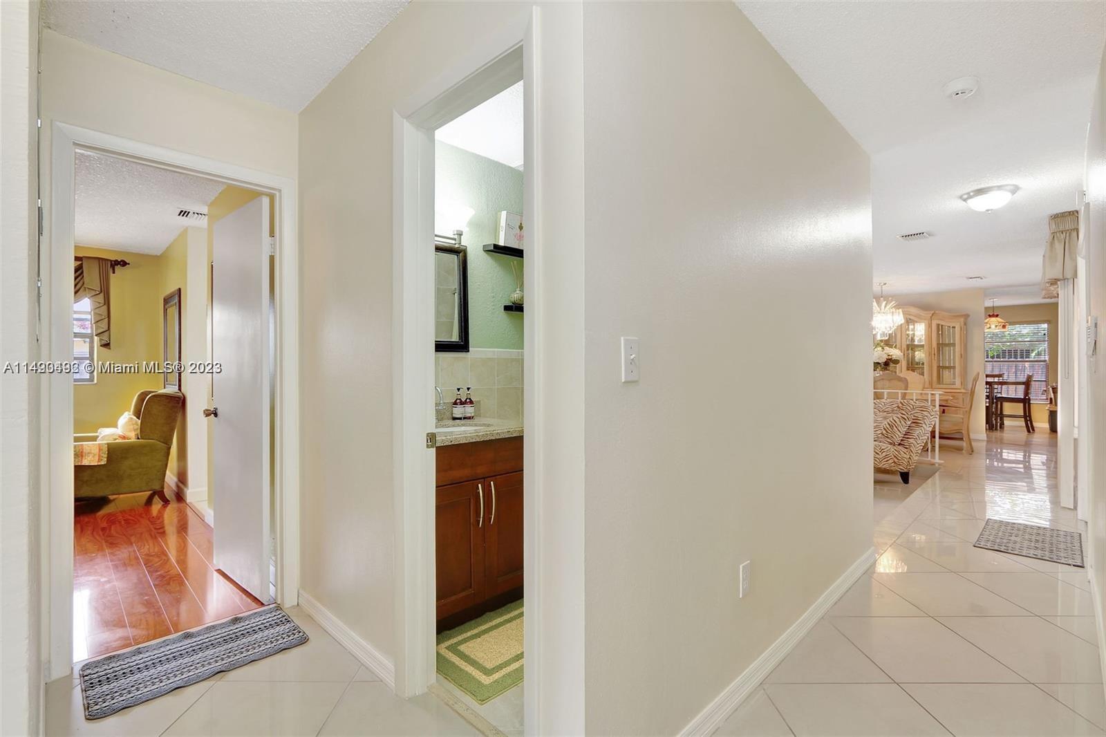 Palmetto Estates Miami, FL 33157 - Photo 17 of 26 a view of a hallway with wooden floor and living room