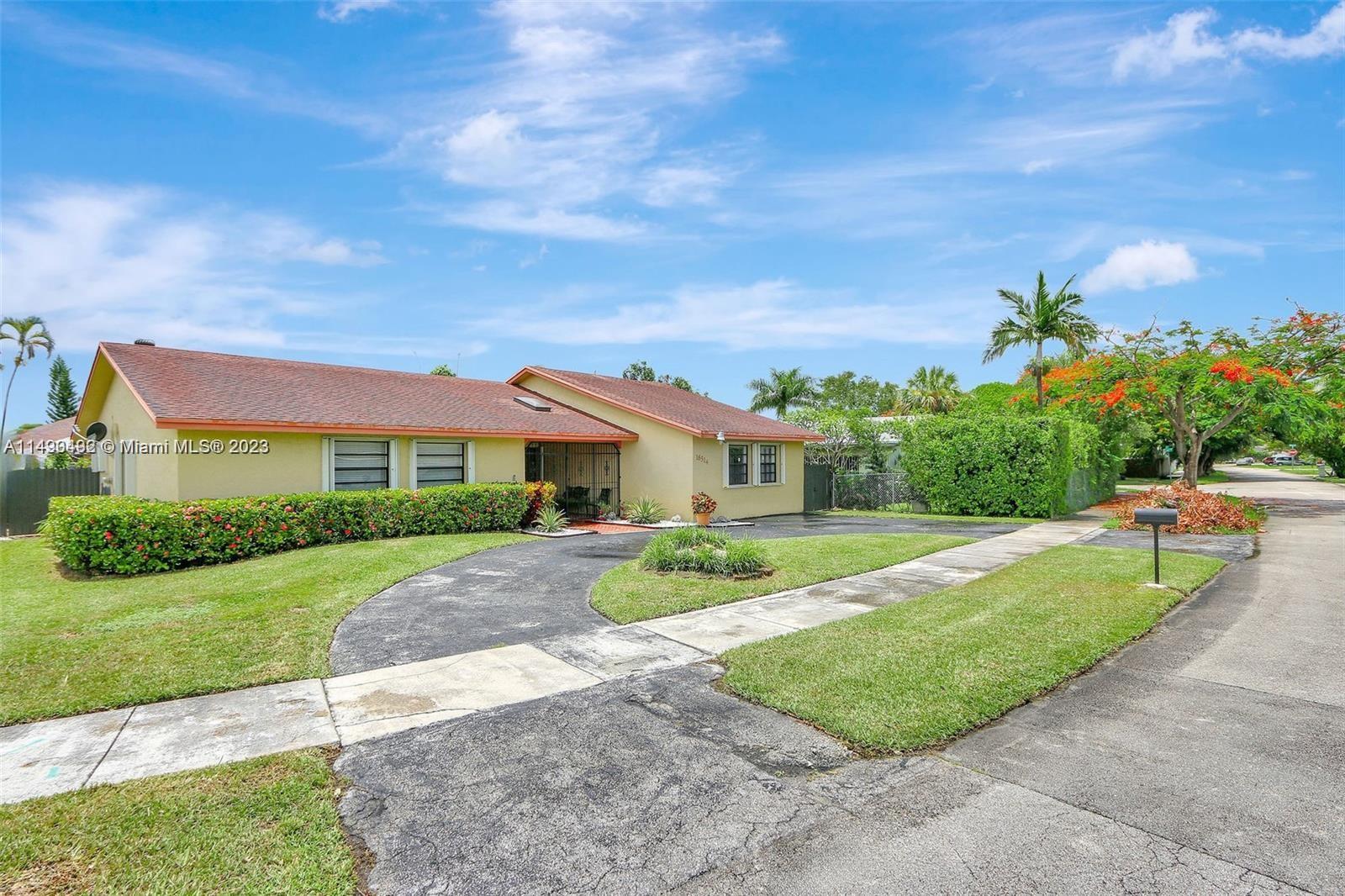 Palmetto Estates Miami, FL 33157 - Photo 2 of 26 a front view of a house with a yard
