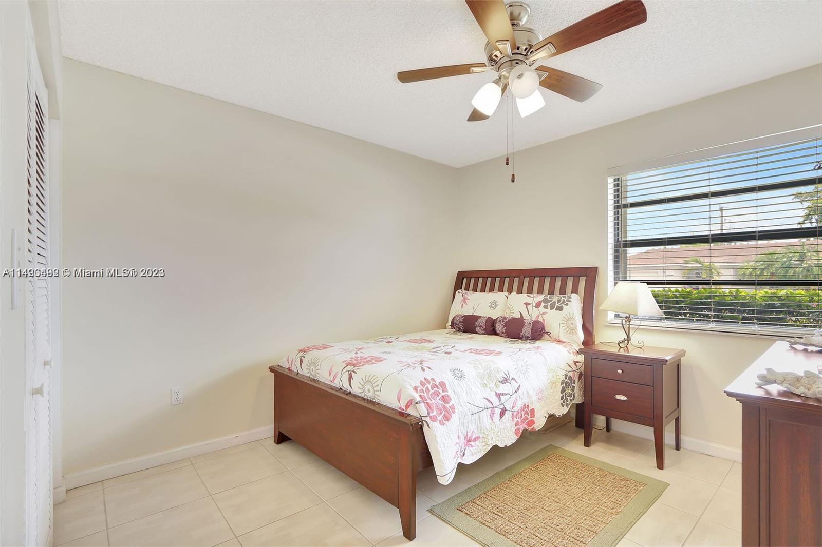 Palmetto Estates Miami, FL 33157 - Photo 24 of 26 a bedroom with a bed and a chandelier