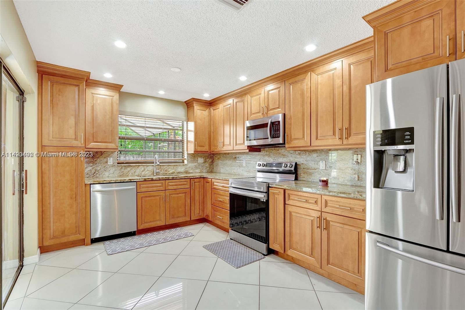 Palmetto Estates Miami, FL 33157 - Photo 9 of 26 a kitchen with a refrigerator stove top oven and sink