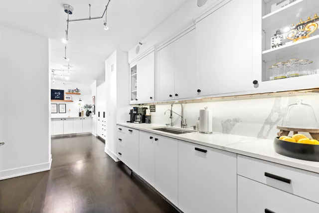 a kitchen with stainless steel appliances a sink a stove and cabinets